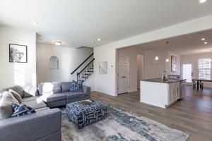 a living room with a couch and a kitchen at Modern Oasis in Beulah Village