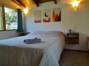 a bedroom with a bed with a towel on it at Cabañas Tierra Verde in El Bolsón