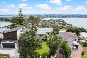 an aerial view of a house with a lake at Harbour Retreat with sea views and BBQ in Whangaparaoa