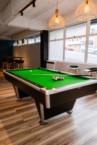 a billiards table in a room with a pool at Haka House Auckland City in Auckland
