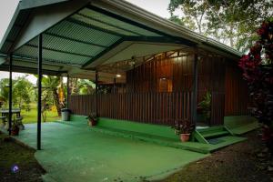 a building with a green roof with a picnic table at Chepe's Chic Bungalow in Fortuna