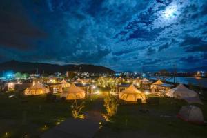 a group of tents in a field at night at Kanonji City - Camp - Vacation STAY 42259v in Kanonji