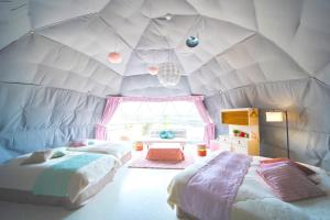 two beds in a room with a ceiling at Kanonji City - Camp - Vacation STAY 42266v in Kanonji