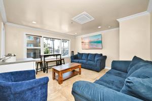 a living room with blue couches and a table at 514 E Oceanfront B in Newport Beach