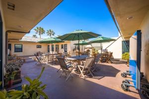 a patio with tables and chairs and umbrellas at 514 E Oceanfront B in Newport Beach