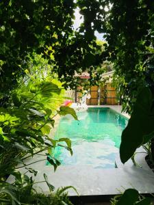 a swimming pool in a yard with trees at Double Mango Villa in Katunayaka