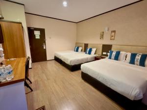 Suan Bee Hotel@Sutera客房内的一张或多张床位
