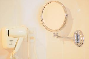 a bathroom with a mirror on the wall at Hoa Binh 1 Hotel in Long Xuyên