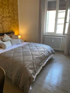 a large bed in a bedroom with two windows at SWEET HOME in Modena
