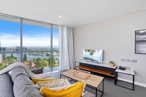 a living room with a couch and a large window at Spectacular Views from Wyndham Apartment in Gold Coast