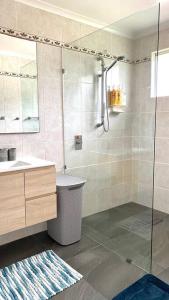 a bathroom with a shower and a sink at Spacious 4-Bedroom house in a shared property in Harristown +48 photos