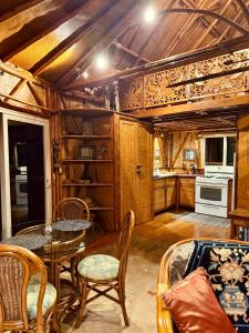 a kitchen with a table and chairs in a room at Maui Eco Retreat in Huelo