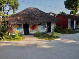 a small building with a thatched roof at CAMPAMENTO CHEZ CAMPOS in Cap Skirring