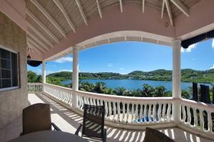 a balcony with a view of the water at Paradise Getaway in Calivigny