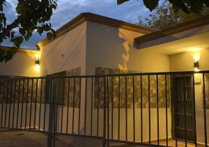 a house with a fence and lights on it at Casa con cochera in Villa Krause
