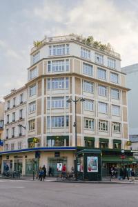 a large building on the corner of a street at Centrally-located Studio Reuilly-Diderot in Paris