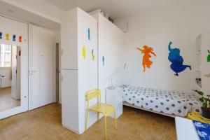 a bedroom with a bed and a yellow chair at Centrally-located Studio Reuilly-Diderot in Paris