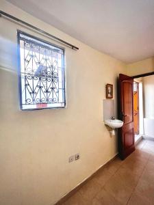 a bathroom with a window and a sink on the wall at Dar al waha medina in Rabat