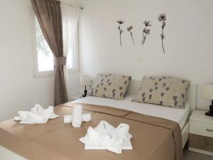 a bedroom with a bed with towels on it at Apartments with parking space Pakostane, Biograd - 22375 in Pakoštane