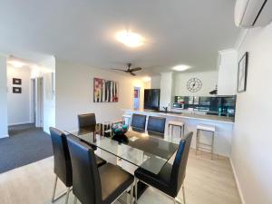 a dining room and kitchen with a table and chairs at Oceanic on Thompson Apartments in Cowes