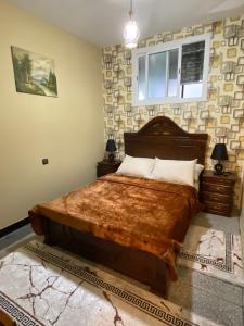 a bedroom with a large bed and a window at Appartement meublé tanger in Tangier