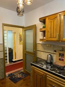 a kitchen with wooden cabinets and a counter top at Appartement meublé tanger in Tangier