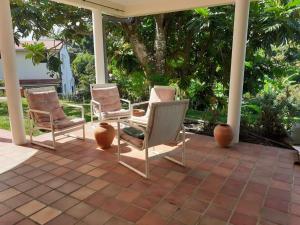 - un ensemble de chaises assises sur une terrasse dans l'établissement Appartement d'une chambre avec jardin clos et wifi a Ducos, à Ducos