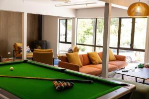 a living room with a pool table and a couch at Haka House Queenstown Lakefront in Queenstown