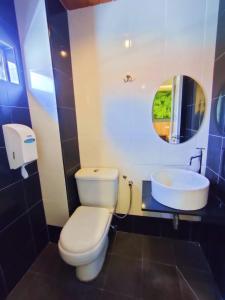 a bathroom with a white toilet and a sink at HOTEL YTS in Brinchang