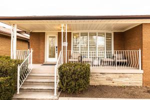 a porch of a house with a white railing at Matilda’s Luxury House in Mississauga