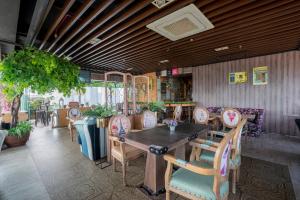 a dining room with a wooden table and chairs at Belviu Hotel Bandung in Bandung