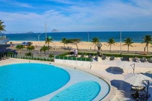 a view of the beach from the balcony of a resort at Hotel Nacional Rio de Janeiro in Rio de Janeiro