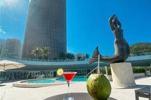 a drink sitting on a table next to a mermaid statue at Hotel Nacional Rio de Janeiro in Rio de Janeiro