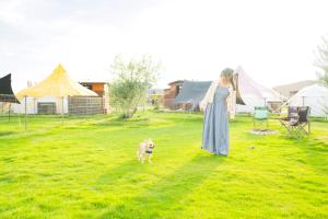 a woman in a dress and a dog in a field at Kanonji City - Camp - Vacation STAY 42263v in Kanonji