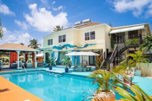 a swimming pool in front of a house at Hidden Gem Barbados in Christ Church