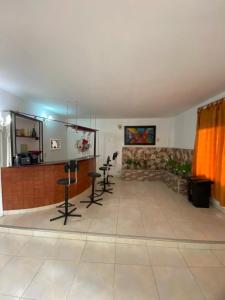 a room with chairs and a bar in a room at HERMOSA CASA CAMPESTRE EN SANTA MARTA in Santa Marta