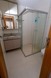 a bathroom with a glass shower and a toilet at Casa 19 da Vila Beija Flor in Mucugê