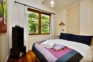 a bedroom with a bed and a window at Blue Gum Church - Artistic Retreat in Beechworth +16 photos