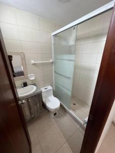 a bathroom with a shower and a toilet and a sink at Casa con piscina Punta Carnero in Salinas