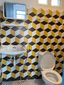 a bathroom with a toilet and a sink at B2 Hotel Savannakhet in Savannakhet