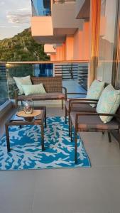 a balcony with couches and tables on a ship at Samaria Club de Playa - Pozos Colorados - By INMOBILIARIA VS in Santa Marta