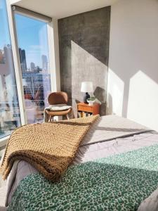a bedroom with a bed and a large window at Stunning 1bed Apartment Downtown 1 min to Petco Park Convention Center in San Diego