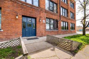 a brick building with a blue door on it at 420 Friendly Downtown Loft KING suite FREE parking in Detroit
