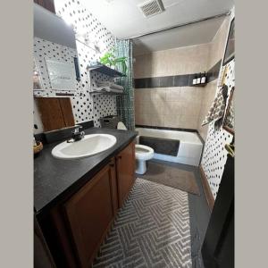 a small bathroom with a sink and a toilet at 420 Friendly BOHO Loft Downtown KING suite FREE parking in Detroit