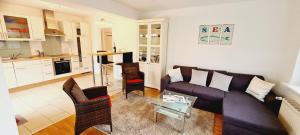 a living room with a couch and a table at Seesternchen-FeWo-Nr-1-EG in Böhl +10 photos