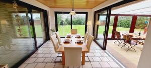 a dining room with a table and chairs on a patio at Seesternchen-FeWo-Nr-1-EG in Böhl