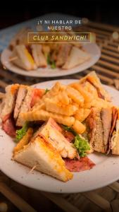 two plates of sandwiches and french fries on a table at Seven Inn Hotel in Medellín