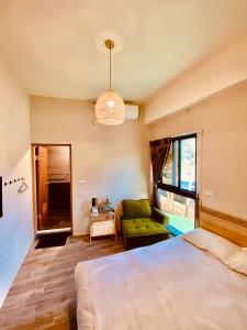 a bedroom with a bed and a green couch at Dreamy Nomads Hostel日月潭背包客 in Yuchi