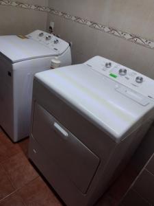 two machines sitting next to each other in a bathroom at Departamento jardín de los poetas in Guadalajara