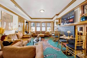 a living room with couches and a tv at The Twin Lions: Bespoke Travel Lodge w/ Speakeasy* in Chicago
